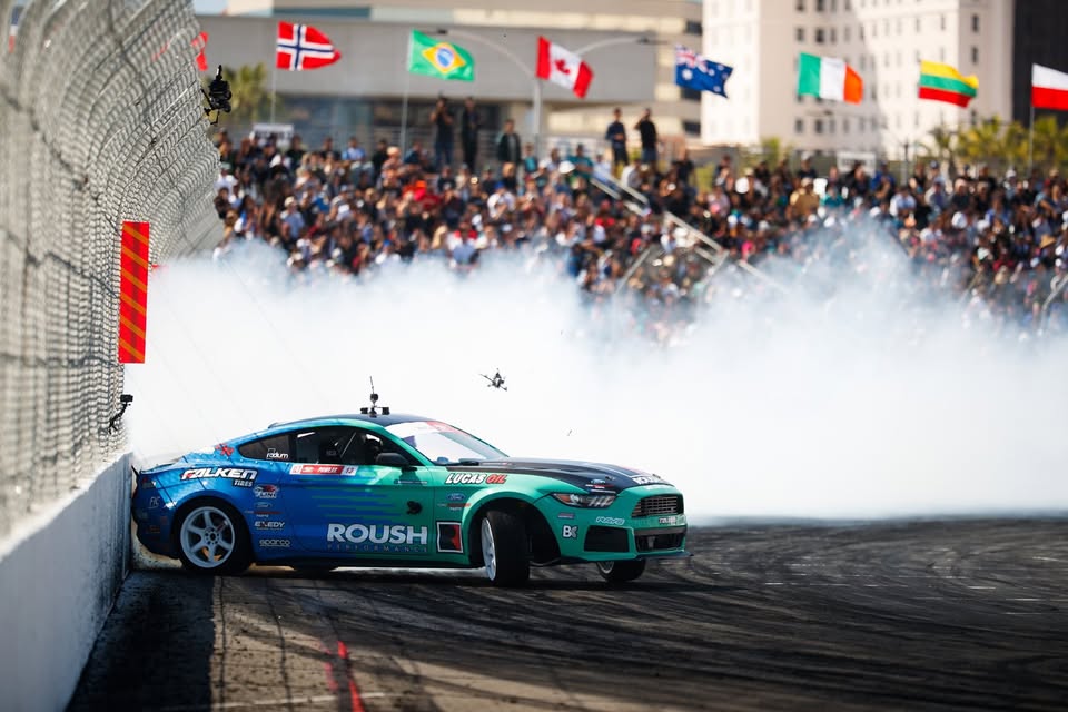 High-Performance Steel in Motorsports Applications – JTP Pawlak- ThoraSteel Race car drifting on a track during a motorsports event with spectators in the background